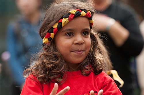 A young girl dancer with Aboriginal headband