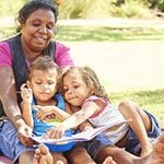 Aboriginal family reading a book