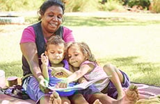 Aboriginal family reading a book