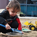 Child playing in the sand at an Aboriginal-led early years centre