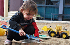 Child playing in the sand at an Aboriginal-led early years centre