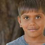 Aboriginal boy by a tree